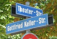 Road signs "Theaterstrasse"
                          ("Theater Street") and
                          "Gottfried-Keller-Strasse"
                          ("Gottfried Keller Street")