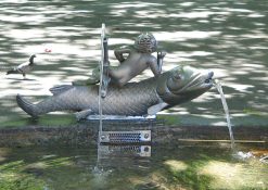 Zurich, Bellevue Fountain,
                                sculpture of a fish with a boy, taken
                                from the back