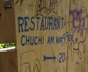 Zurich, Kloster-Fahr-Weg (Fahr Monastery
                        Way), graffiti at a wooden wall as signpost to
                        the Restaurant "Chuchi" (Zurich German
                        for: Restaurant "Kitchen")