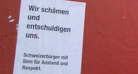 Poster
              indicating the people's survey against foreigners saying
              "We are ashamed and apologize. Swiss civilians with
              sense for modesty and respect"