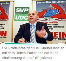 Ueli
                            Maurer presenting the racist SVP rat poster
                            against the Socialist Party in April 2004