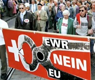 poster of
                            SVP against EEA in 1992 with the lie that
                            Switzerland would be grilled and surrounded
                            and amputated, respectively the lie is that
                            a membership of EEA would also be a
                            membership of EU - and the poster is in Nazi
                            colors black (for EEA and EU), red and
                            white